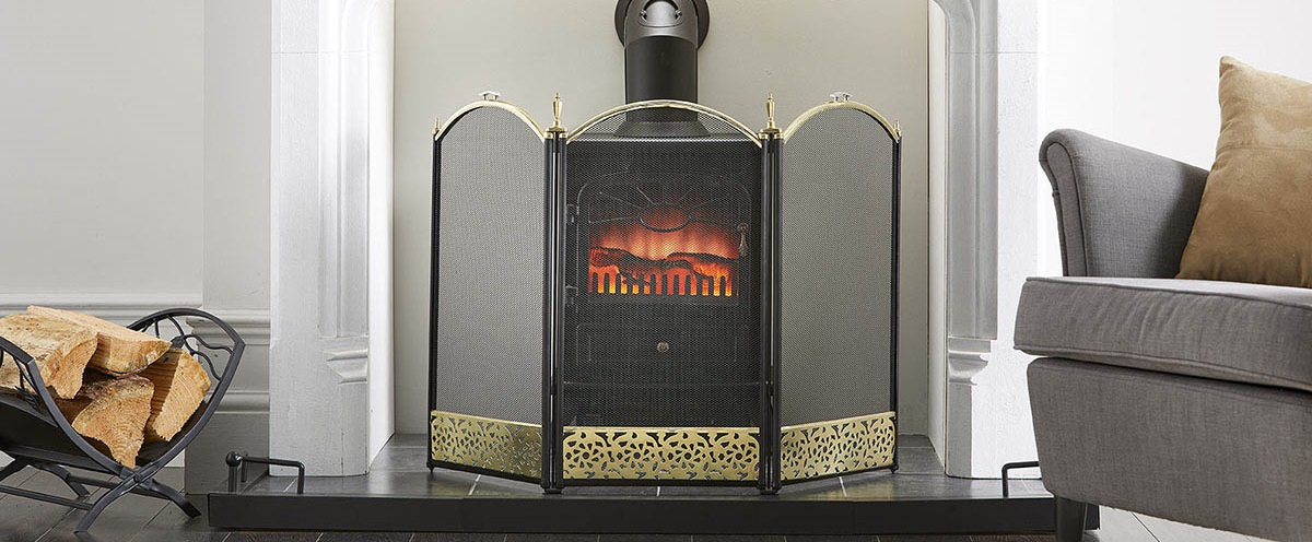 fires surround in front of a fire finished in black and brass