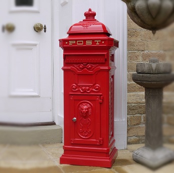 wholesale post box with a victorian style stands outside a house with a white door