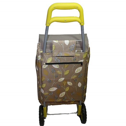 A green wheeled shopping trolly with a leaf design fabric and a yellow drag handle